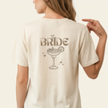 The Bride Shirt in Gold mit Cocktailglas-Motiv als Rückenprint für den JGA